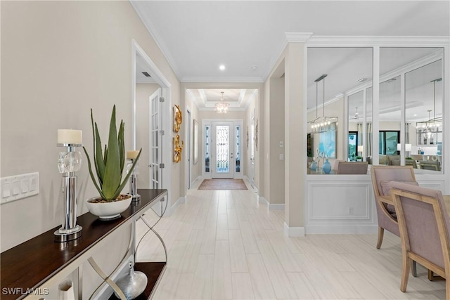 hallway featuring crown molding, recessed lighting, a notable chandelier, and baseboards