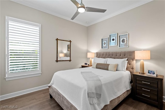 bedroom with ornamental molding, dark wood-style flooring, ceiling fan, and baseboards