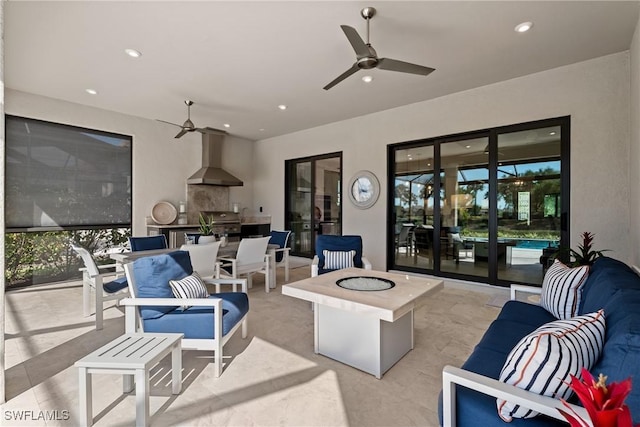 view of patio / terrace featuring an outdoor living space with a fire pit, an outdoor kitchen, and a ceiling fan