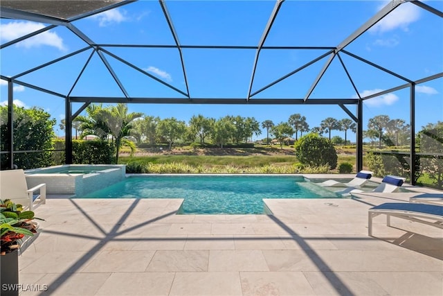 view of swimming pool featuring a pool with connected hot tub, a lanai, and a patio area