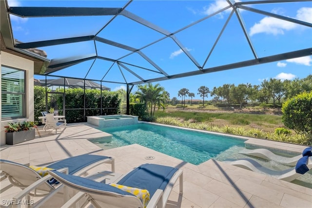 view of pool featuring a lanai, a pool with connected hot tub, and a patio area