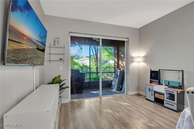 doorway to outside featuring light wood finished floors and baseboards