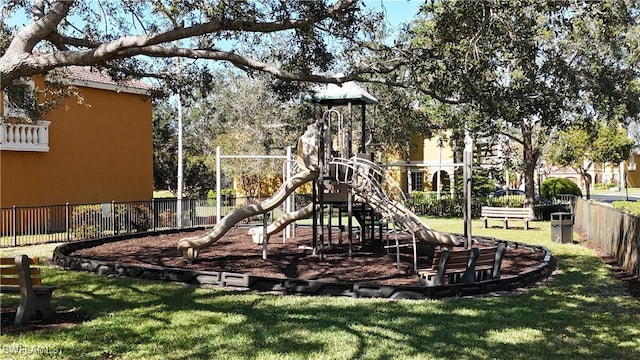 communal playground with fence and a lawn