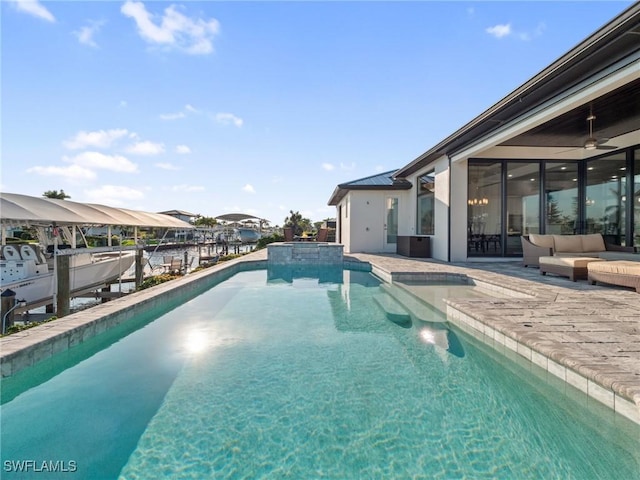 view of swimming pool with an outdoor hangout area, ceiling fan, a patio area, and a pool with connected hot tub