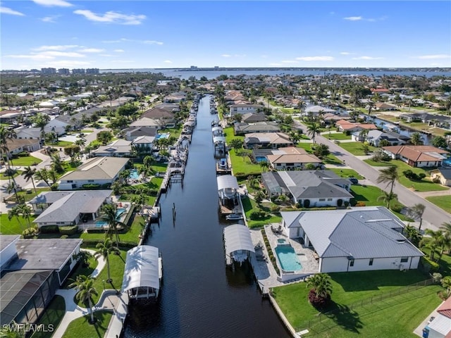 drone / aerial view with a water view and a residential view