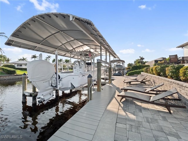 view of dock with a water view and boat lift