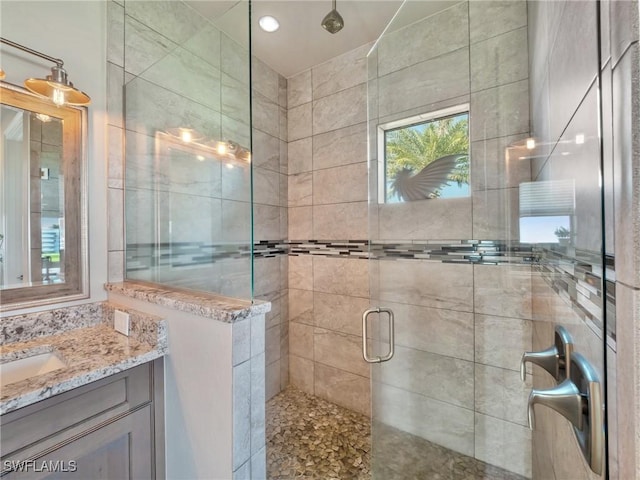 bathroom with a stall shower and vanity