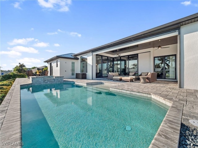 view of pool featuring a patio area, ceiling fan, a pool with connected hot tub, and outdoor lounge area