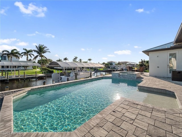 view of pool with a water view, a pool with connected hot tub, a dock, and a patio