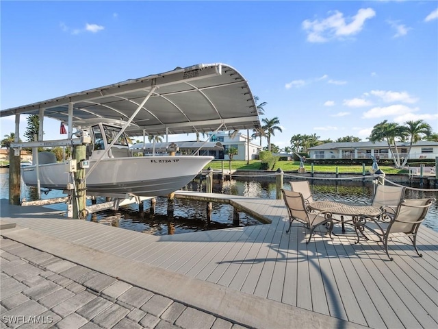 dock area with a water view and boat lift