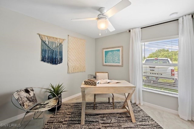 home office featuring a ceiling fan and baseboards