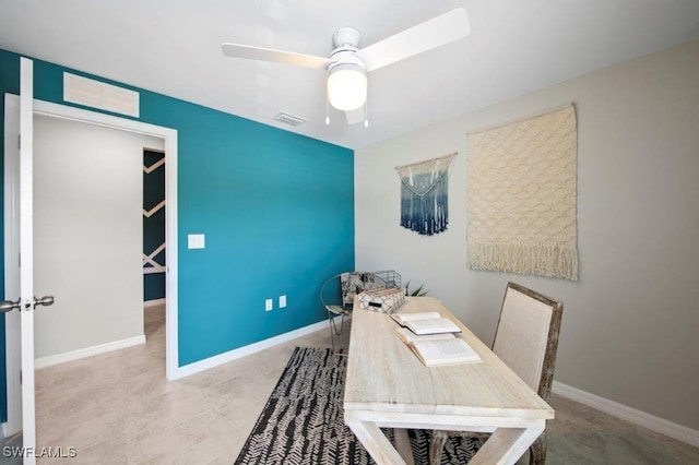 office space with ceiling fan, visible vents, and baseboards