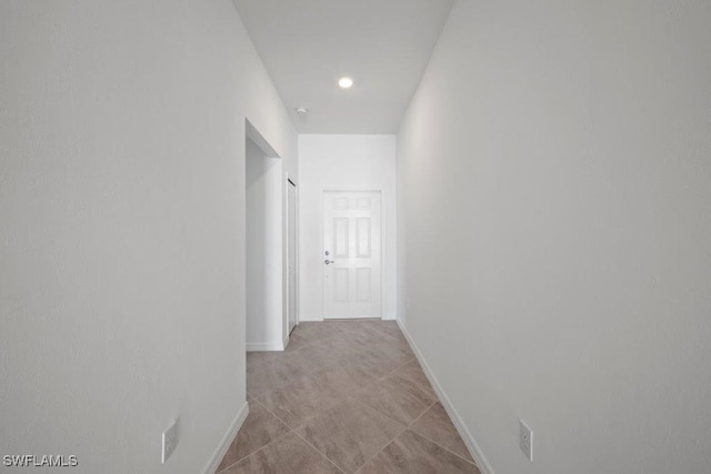 hallway featuring baseboards