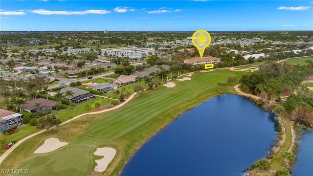 birds eye view of property with a water view and golf course view