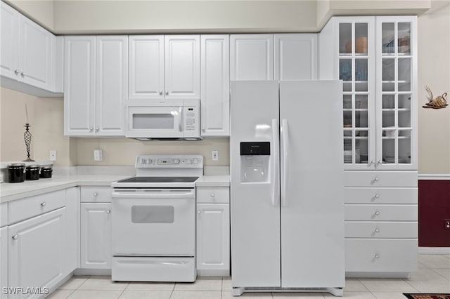 kitchen featuring white appliances, white cabinetry, and light countertops