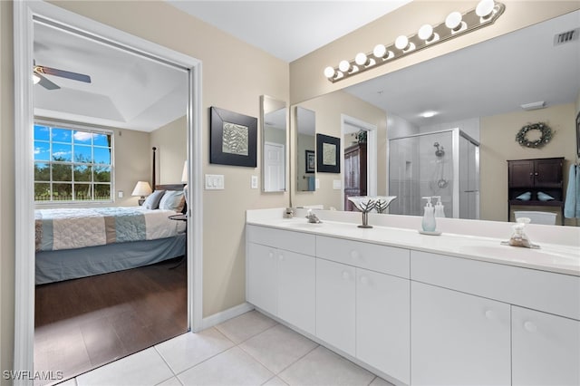 bathroom with tile patterned flooring, a sink, visible vents, a shower stall, and ensuite bath