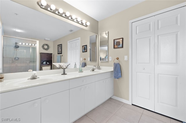 bathroom featuring double vanity, a closet, a sink, and tile patterned floors