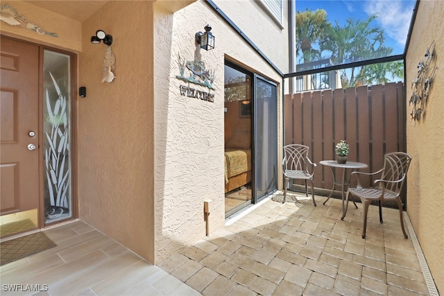 entrance to property featuring stucco siding