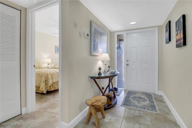 foyer with light tile patterned floors and baseboards