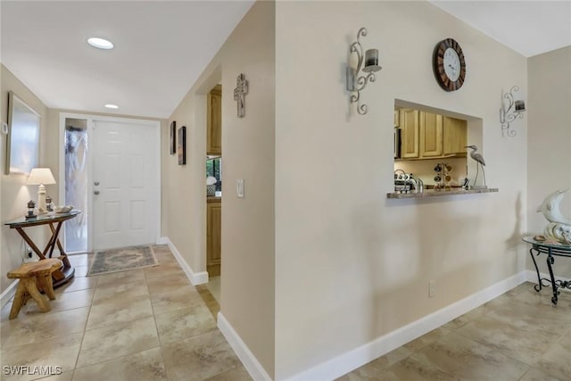 foyer entrance featuring light tile patterned floors, recessed lighting, and baseboards