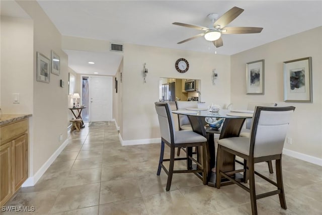 dining area featuring visible vents, ceiling fan, baseboards, and light tile patterned flooring