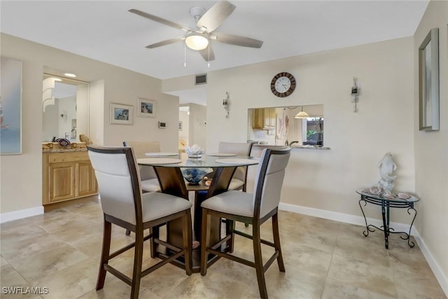 dining area featuring a ceiling fan and baseboards