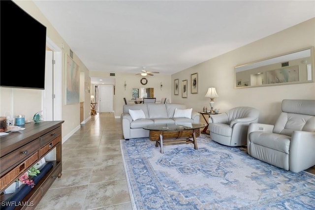 living room with visible vents, light tile patterned flooring, a ceiling fan, and baseboards