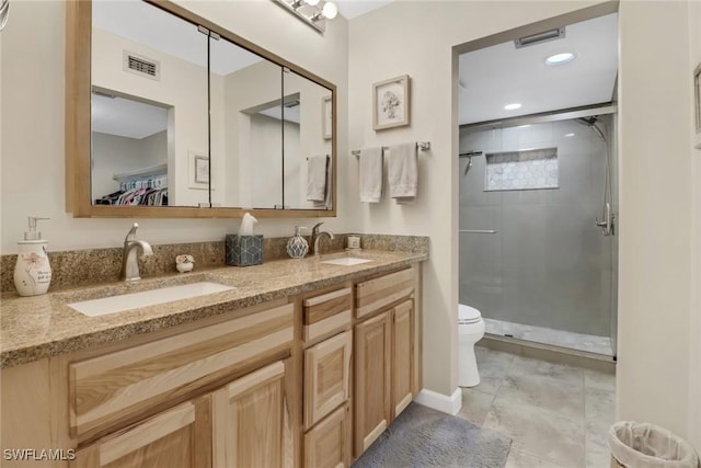 full bathroom with visible vents, a sink, a shower stall, and toilet