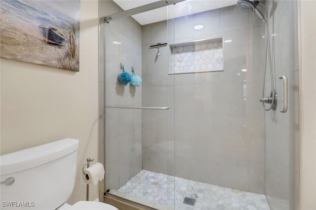 full bath featuring toilet and a shower stall