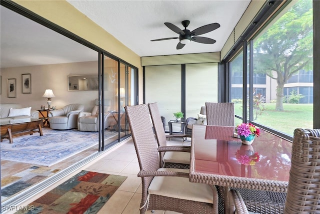 sunroom / solarium featuring ceiling fan