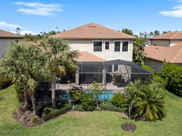 rear view of property with a lanai, a lawn, and a patio