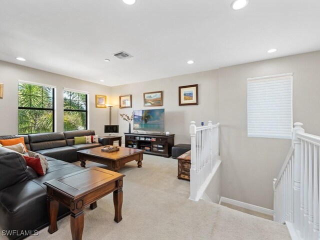 living area with light carpet, baseboards, visible vents, and recessed lighting