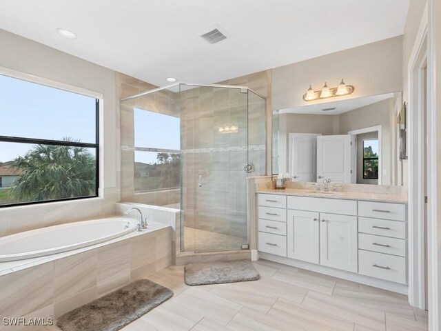 full bathroom featuring a shower stall, visible vents, a bath, and vanity