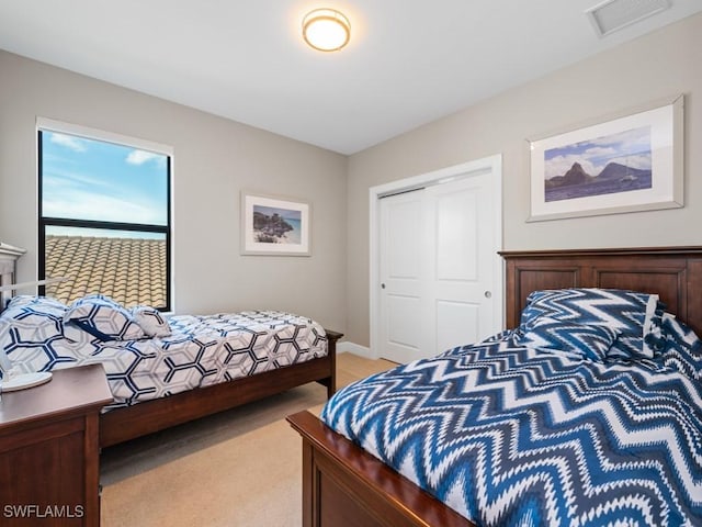 bedroom with a closet and visible vents