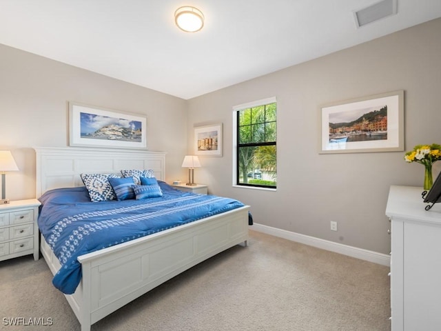 bedroom featuring light colored carpet, visible vents, and baseboards