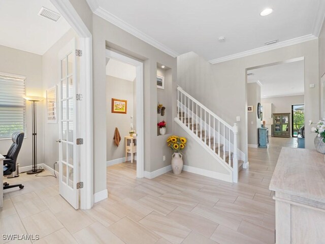 stairway with french doors, visible vents, crown molding, and baseboards