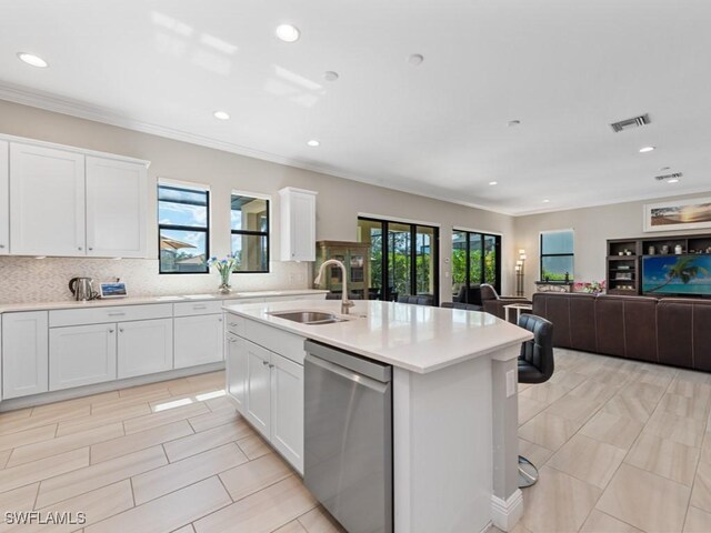 kitchen featuring dishwasher, a sink, visible vents, and a healthy amount of sunlight