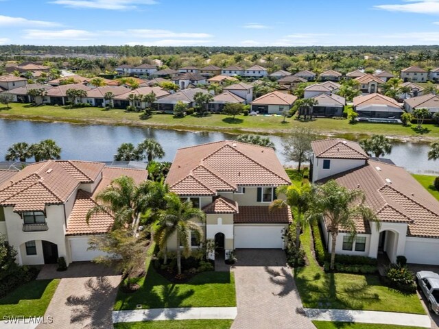 birds eye view of property featuring a residential view and a water view