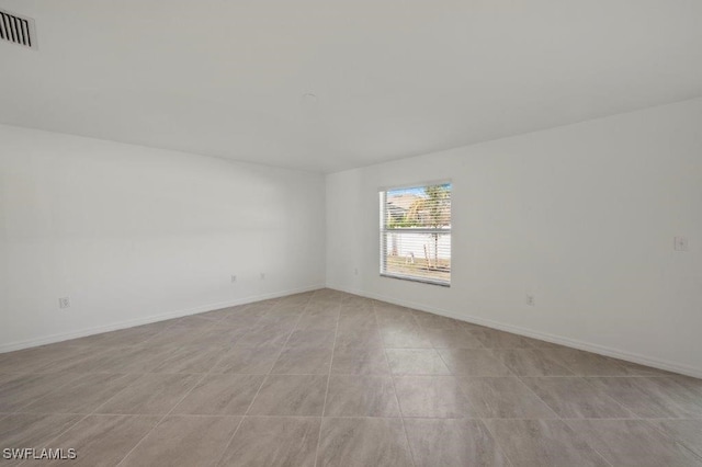 empty room featuring visible vents and baseboards