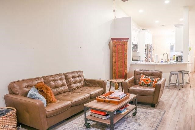 living room featuring recessed lighting and light wood finished floors