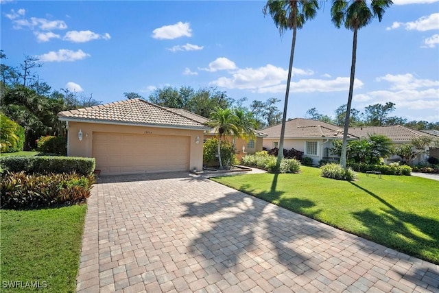 12755 Huntters Ridge Dr, Bonita Springs, FL 34135 - view of front of property featuring a garage, a tile roof, decorative driveway, stucco siding, and a front lawn