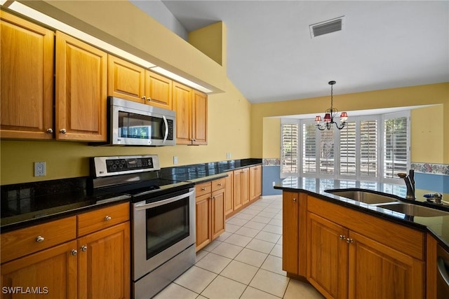 kitchen featuring light tile patterned floors, visible vents, brown cabinetry, appliances with stainless steel finishes, and a sink