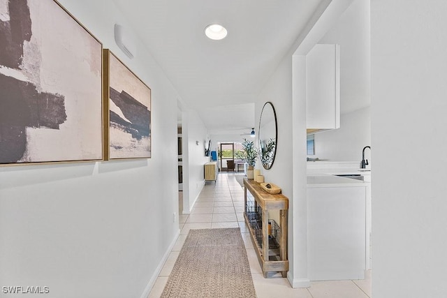 hall with light tile patterned floors and baseboards