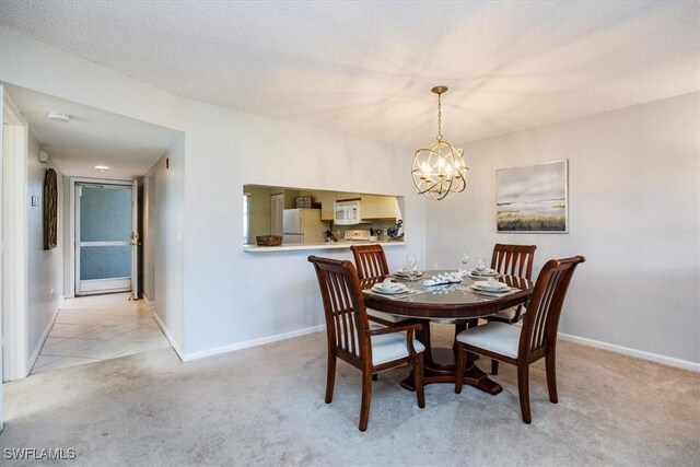 dining area featuring baseboards, a notable chandelier, and light colored carpet