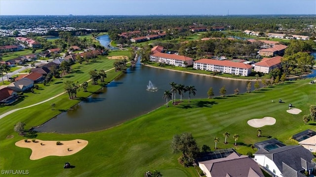 drone / aerial view with view of golf course, a water view, and a residential view