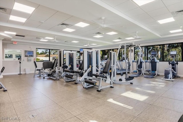 workout area featuring a paneled ceiling, a raised ceiling, and visible vents