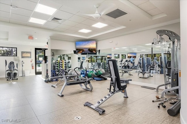 workout area featuring a paneled ceiling, visible vents, and crown molding