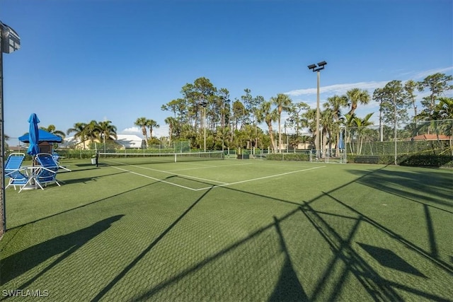 view of tennis court with fence