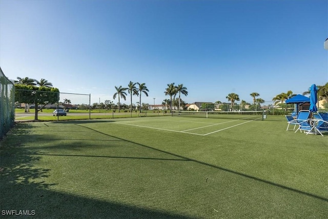 view of tennis court featuring fence