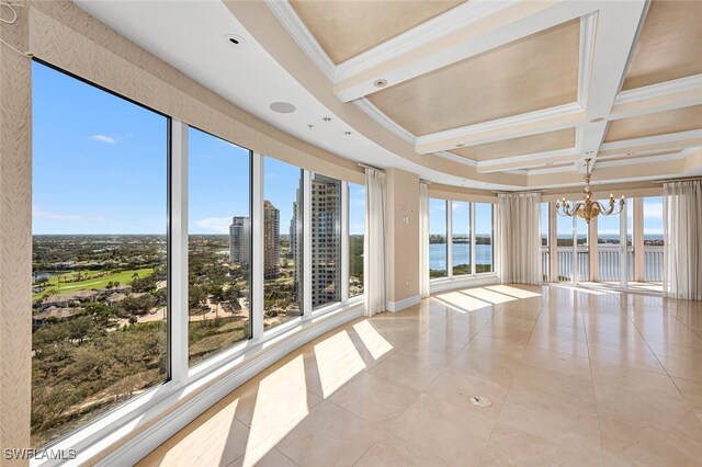 unfurnished sunroom featuring a chandelier, coffered ceiling, a water view, and beamed ceiling